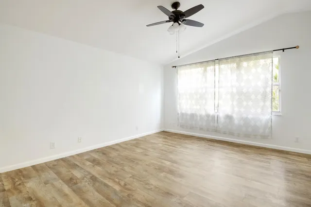 an empty room with a empty space and windows