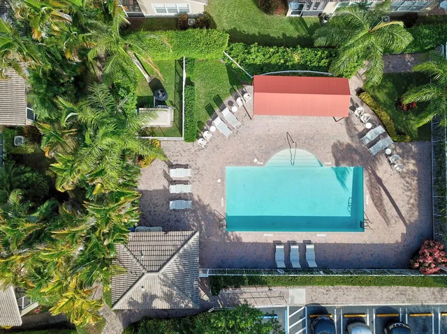 an aerial view of a house with a yard and a lot of flower plants