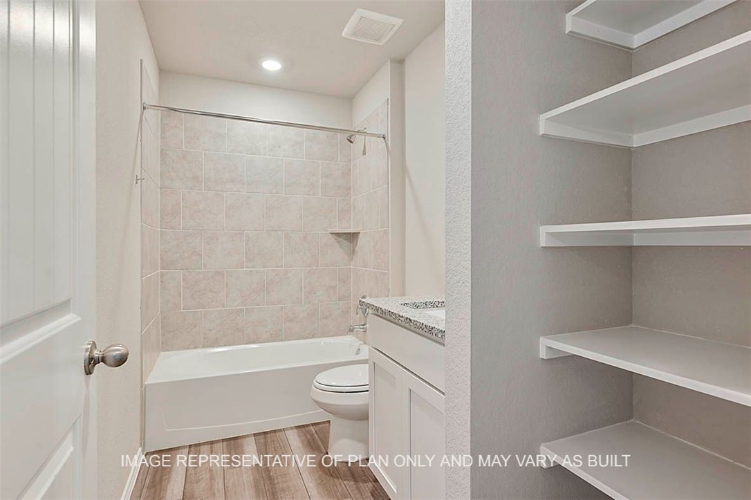 5407 Bear Run Bryan, TX 77807 - Photo 10 of 13 a bathroom with a toilet and a shower