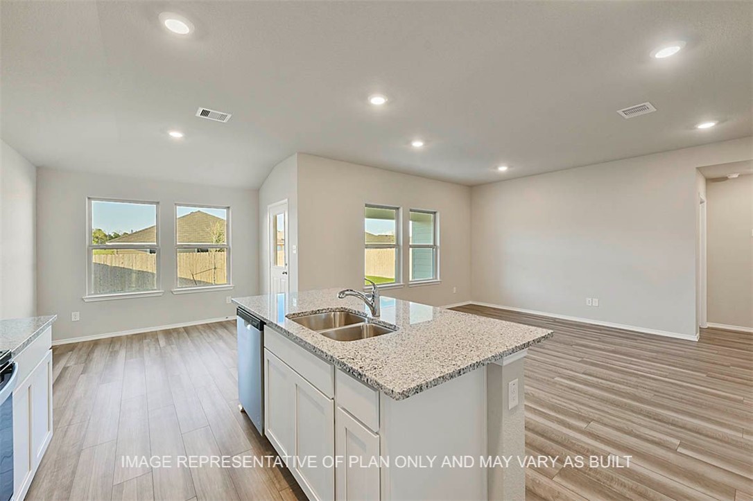 5407 Bear Run Bryan, TX 77807 - Photo 12 of 13 a kitchen with granite countertop a sink and wooden floor