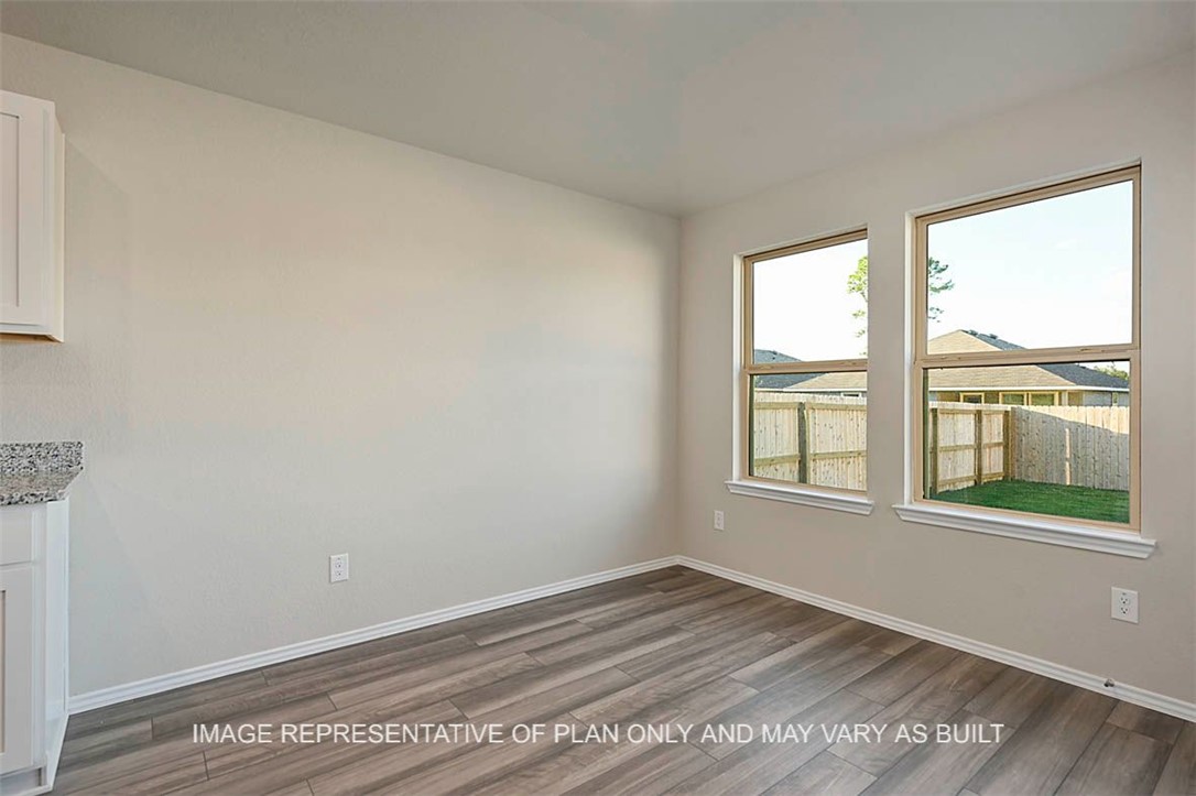 5407 Bear Run Bryan, TX 77807 - Photo 4 of 13 a view of empty room with wooden floor and fan