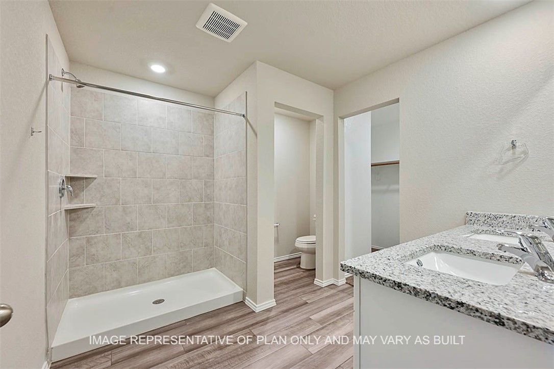 5407 Bear Run Bryan, TX 77807 - Photo 6 of 13 a bathroom with a granite countertop sink a toilet and shower