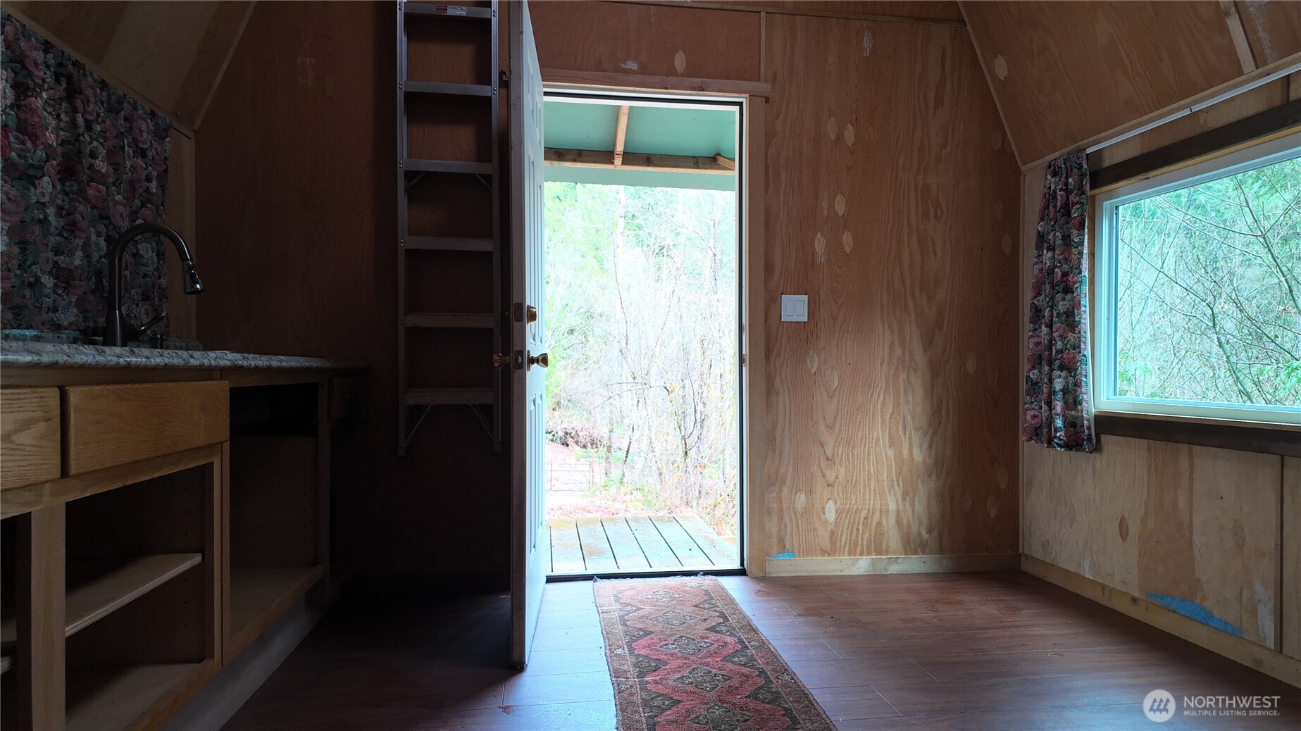 0 Cascade River Road, Unit D1203 Marblemount, WA 98267 - Photo 23 of 32 a view of an empty room with wooden floor and a window