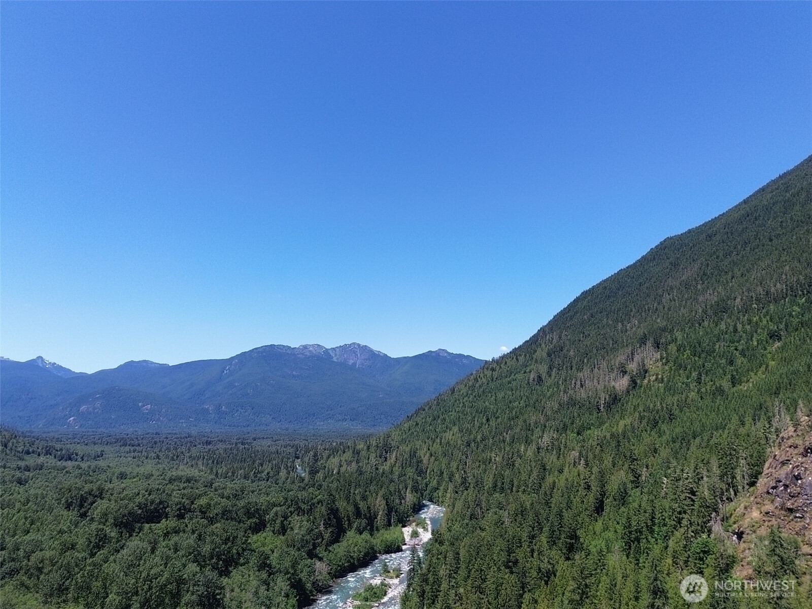 0 Cascade River Road, Unit D1203 Marblemount, WA 98267 - Photo 28 of 32 a view of a mountain range with a lush green forest