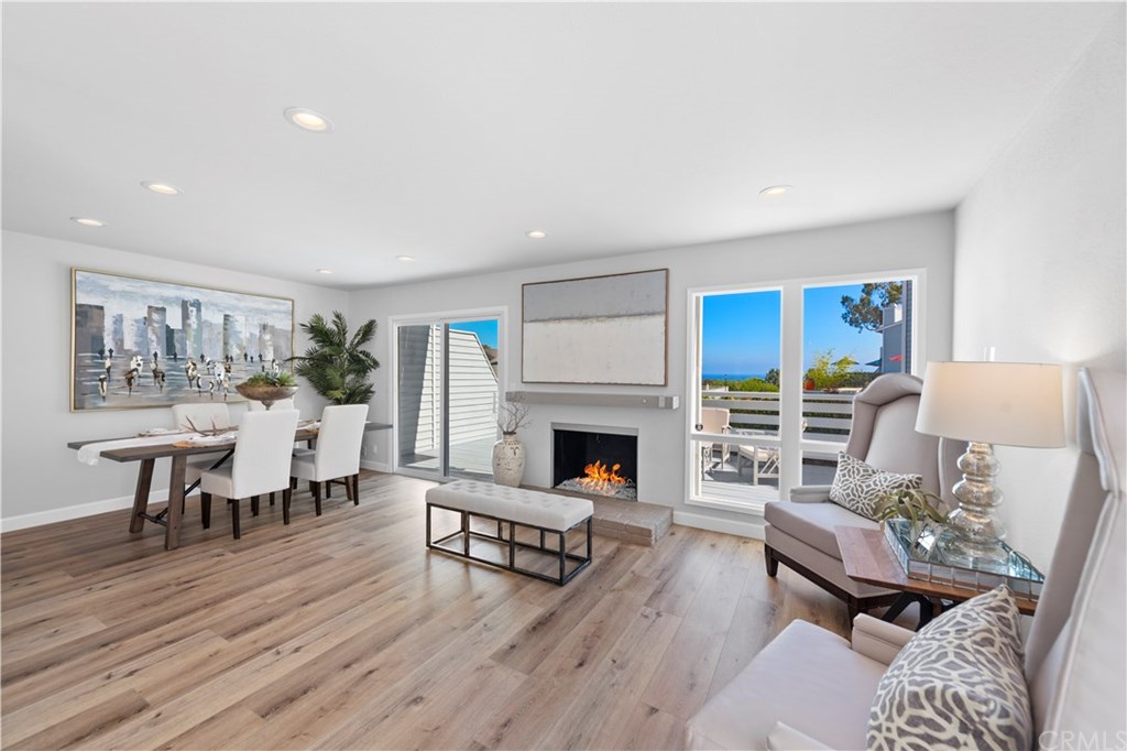 24592 Harbor View Drive, Unit A Dana Point, CA 92629 - Photo 3 of 32 A beautiful white fire glass fireplace graces the living room to keep you warm during the cool days & evenings.