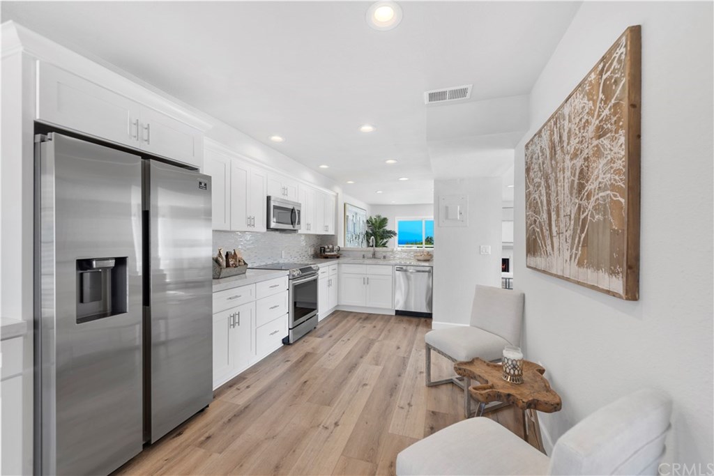 24592 Harbor View Drive, Unit A Dana Point, CA 92629 - Photo 9 of 32 The ceiling was raised and the kitchen was expanded which doubled in size by removing a wall. And, opening up the wall at the far end allowed for a great ocean view to enjoy while your'e prepping a meal.