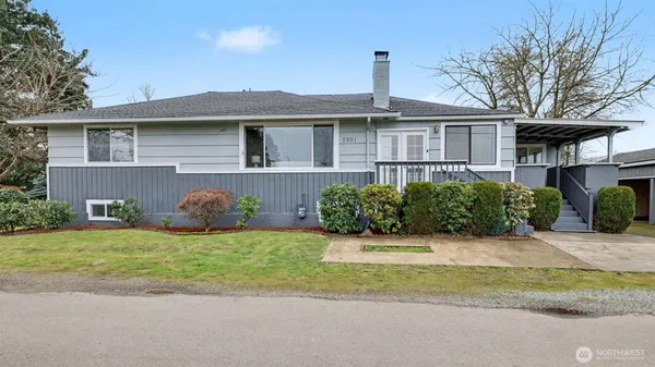 a front view of a house with a garden and yard