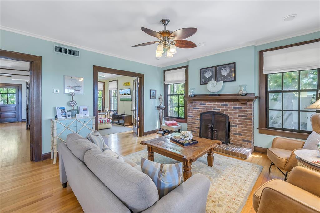 516 Gulf Boulevard Indian Rocks Beach, FL 33785 - Photo 24 of 97 a living room with furniture a fireplace and a large window