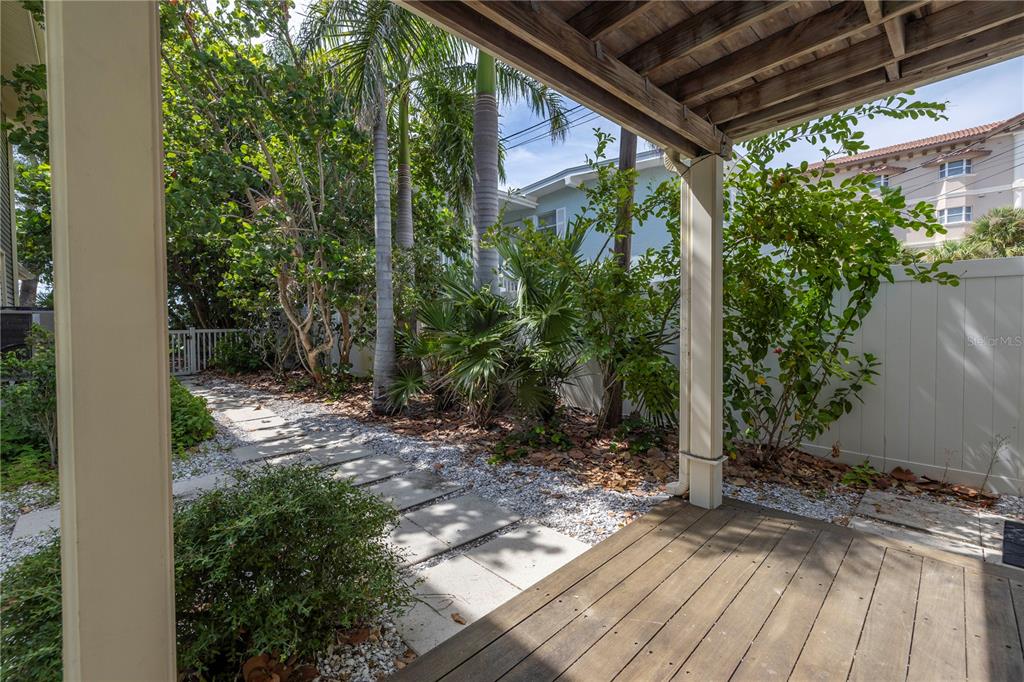 516 Gulf Boulevard Indian Rocks Beach, FL 33785 - Photo 57 of 97 a view of backyard with plants and outdoor seating