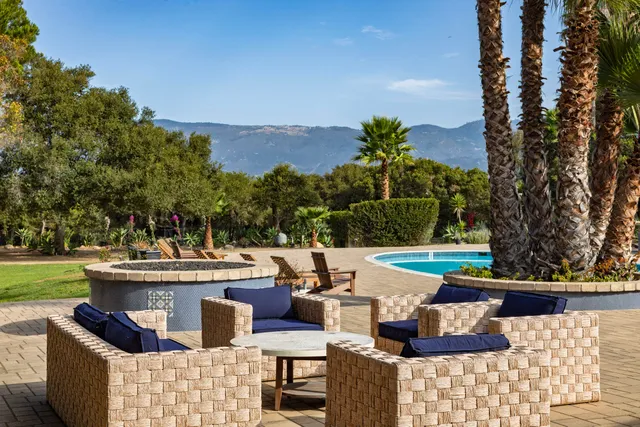 a view of swimming pool with outdoor seating and plants