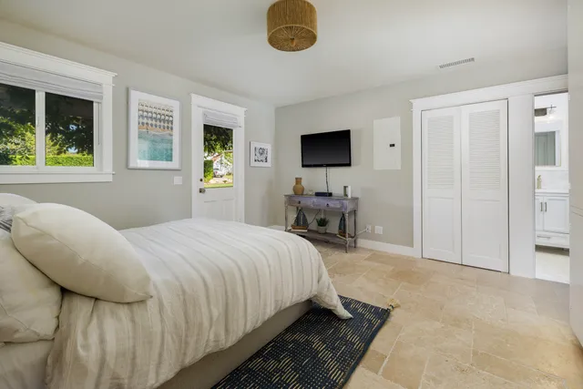 a bedroom with a bed and a television