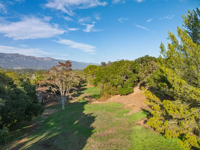 a view of a yard with mountains in the background