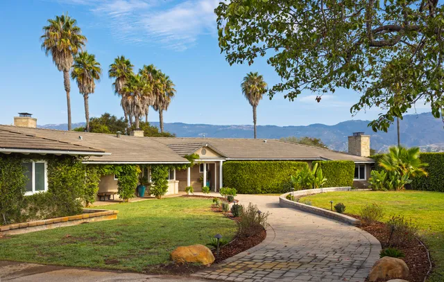 a view of a house with swimming pool and yard with furniture