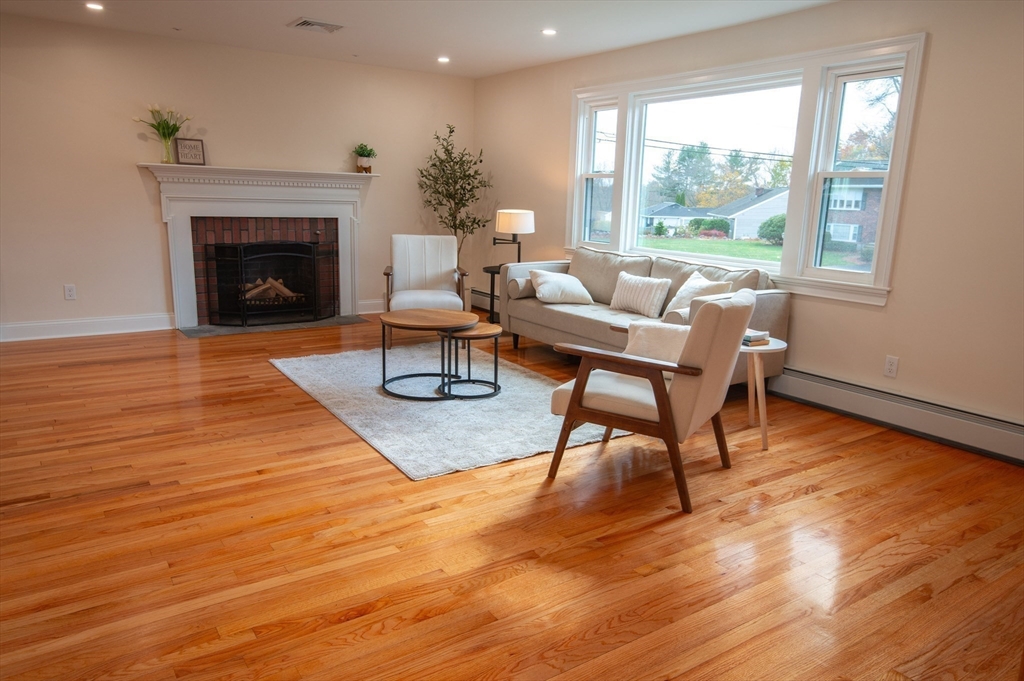 33 Marla Lane Reading, MA 01867 - Photo 11 of 42 a living room with furniture and a fireplace