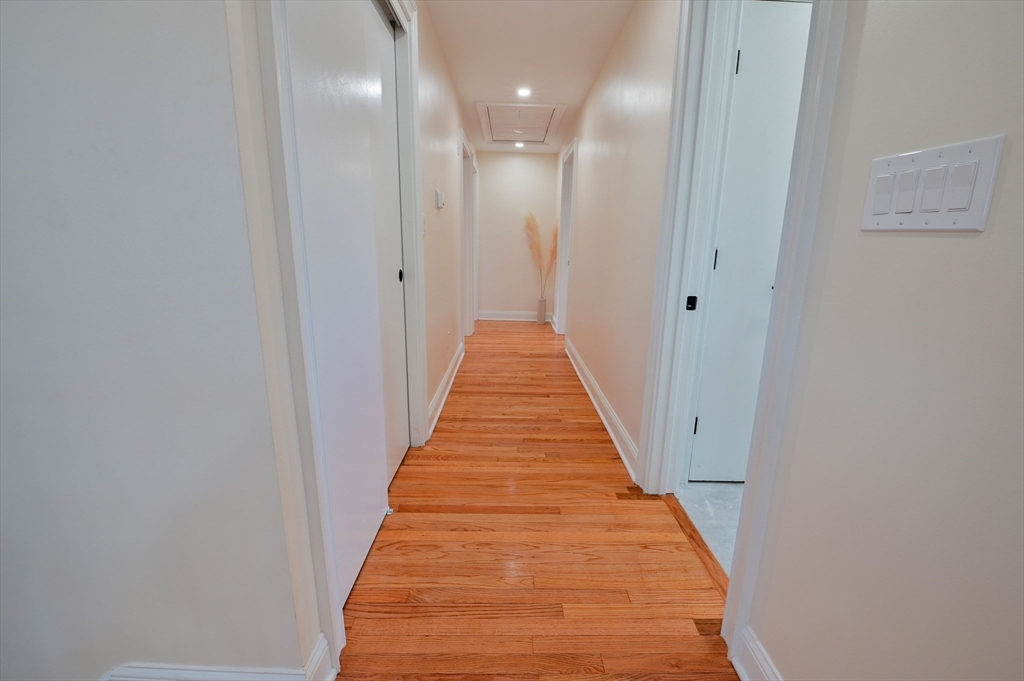 33 Marla Lane Reading, MA 01867 - Photo 14 of 42 a view of a hallway with wooden floor and staircase