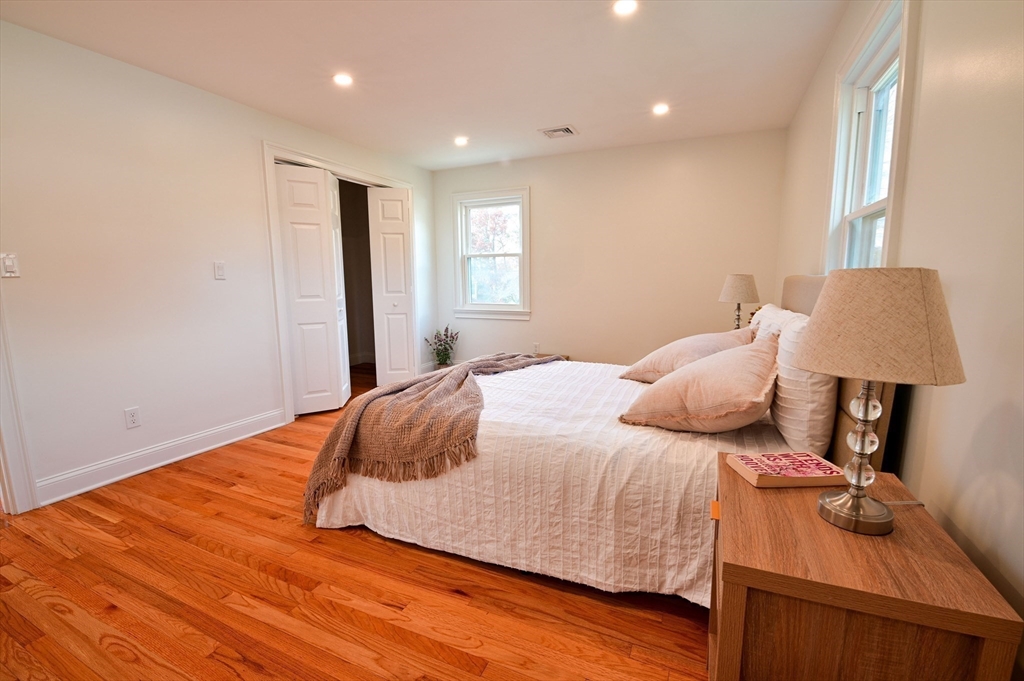 33 Marla Lane Reading, MA 01867 - Photo 16 of 42 a bedroom with a bed and a lamp