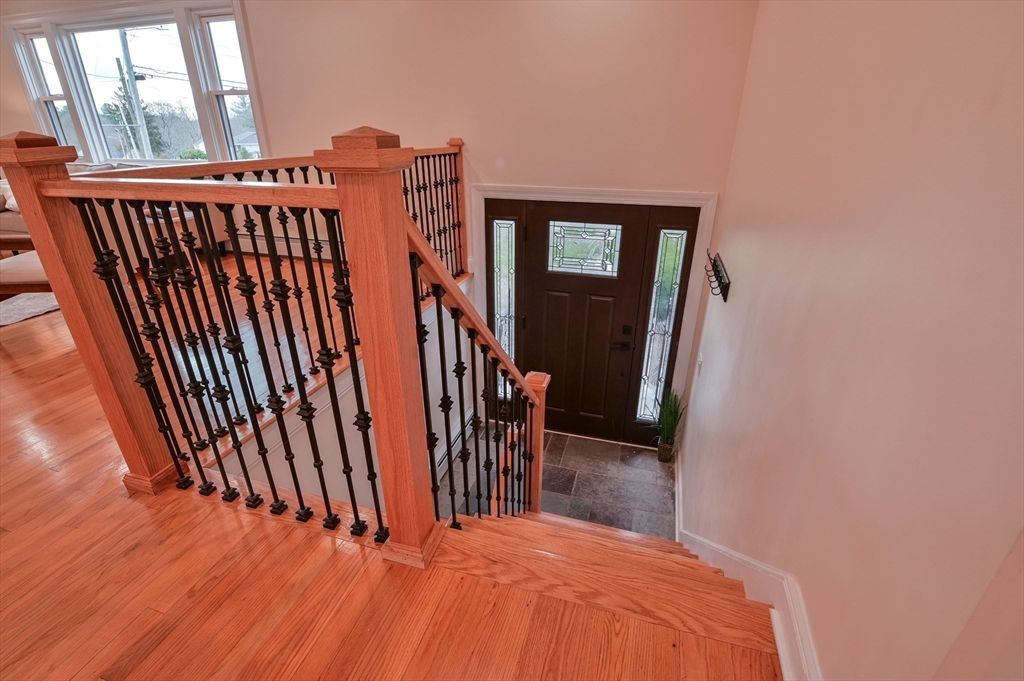 33 Marla Lane Reading, MA 01867 - Photo 27 of 42 a view of a hallway with wooden floor and stairs