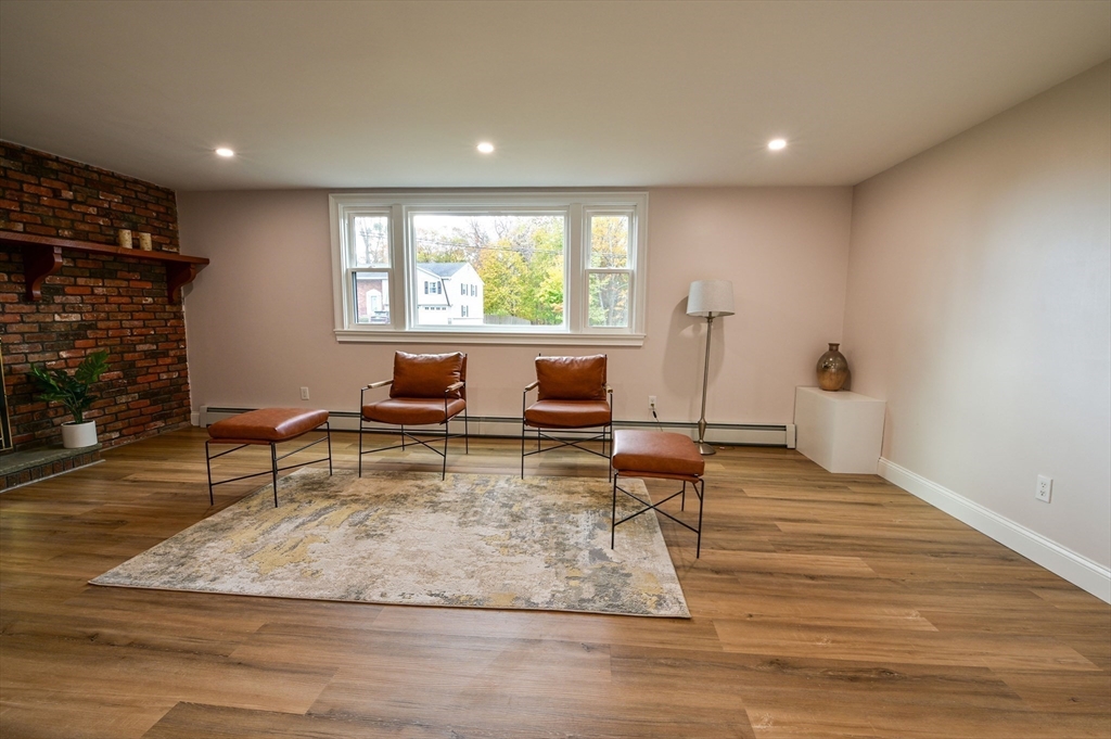 33 Marla Lane Reading, MA 01867 - Photo 30 of 42 a living room with fireplace furniture and a large window