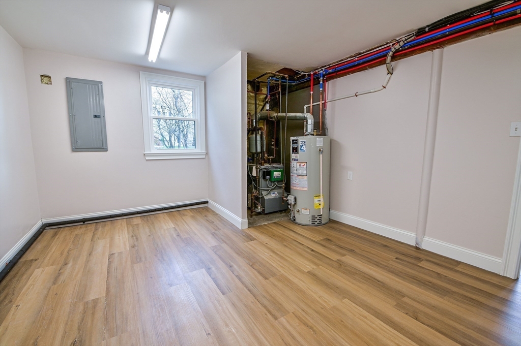 33 Marla Lane Reading, MA 01867 - Photo 33 of 42 a view of an empty room with wooden floor and a window