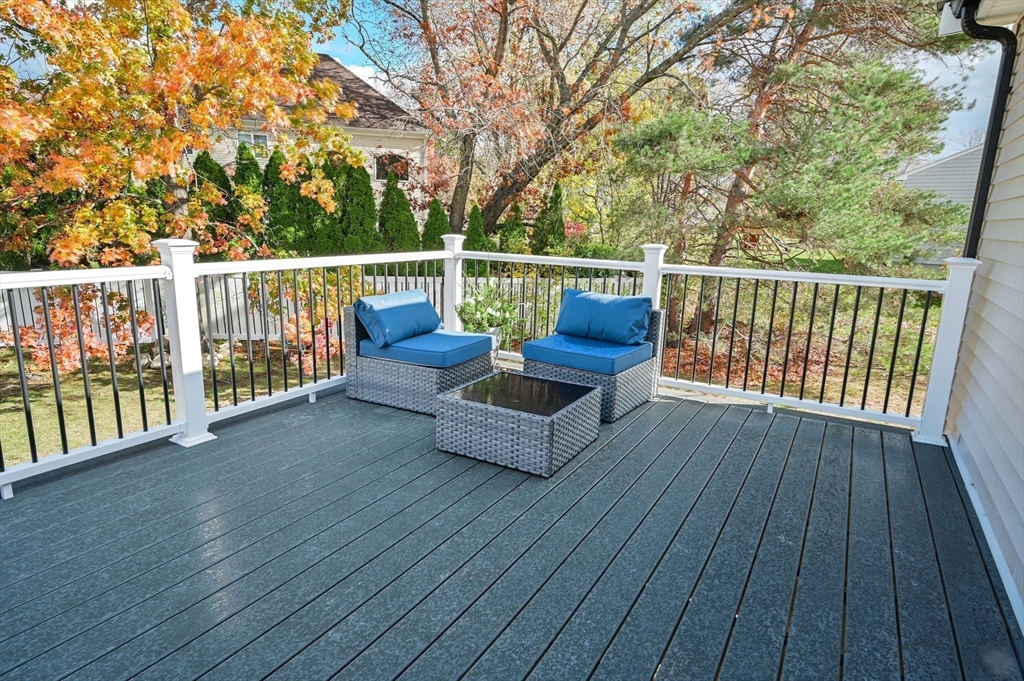 33 Marla Lane Reading, MA 01867 - Photo 35 of 42 a view of a deck with couches wooden floor and fence