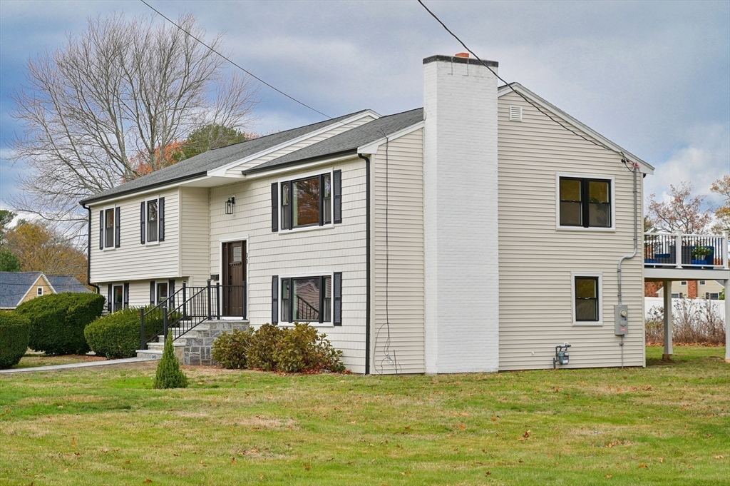 33 Marla Lane Reading, MA 01867 - Photo 39 of 42 a house that has a big yard in front of it