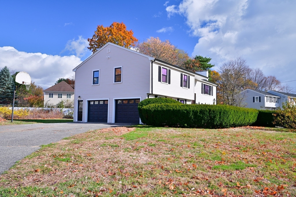 33 Marla Lane Reading, MA 01867 - Photo 41 of 42 a front view of a house with a yard and garage