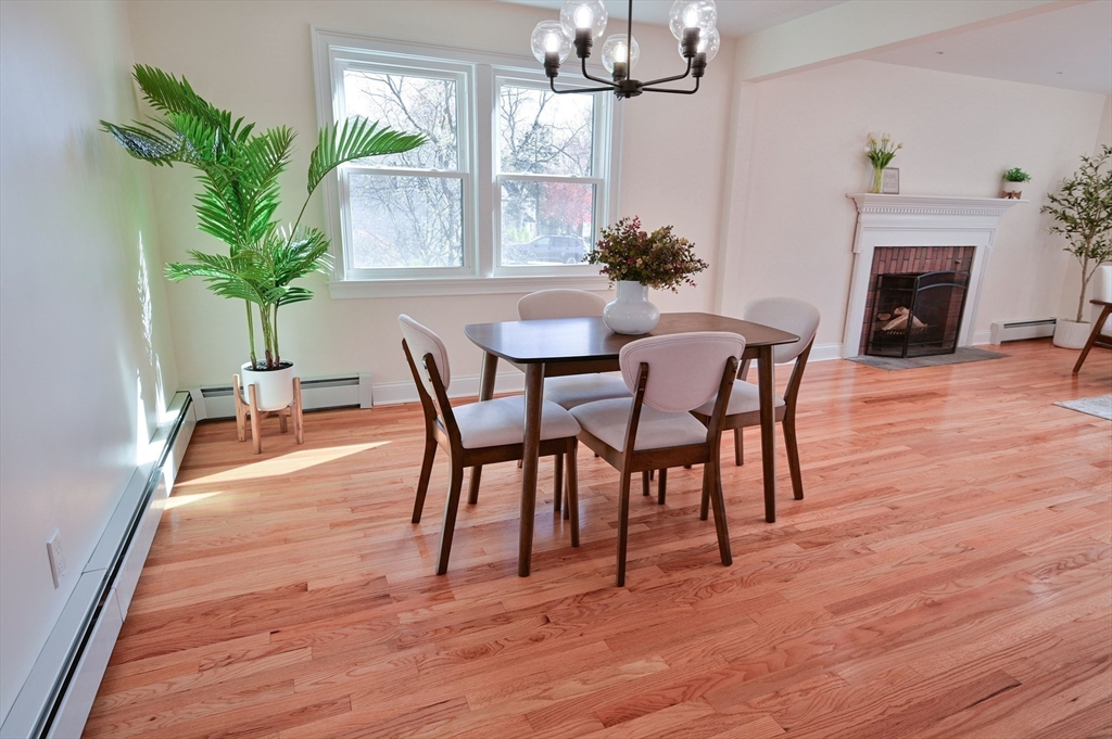 33 Marla Lane Reading, MA 01867 - Photo 10 of 42 a dining room with furniture potted plants and wooden floor