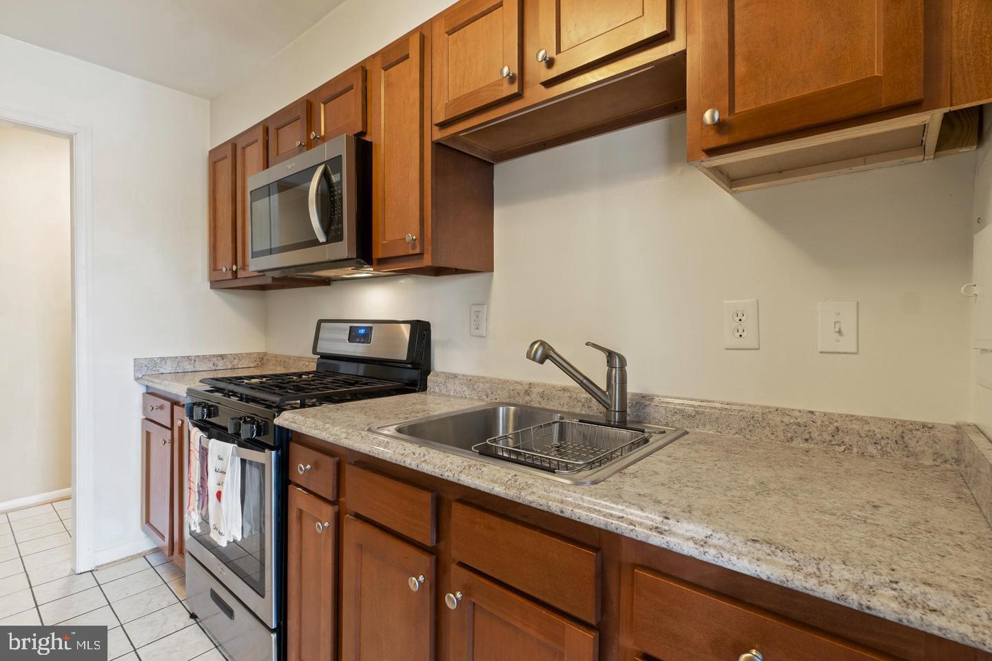 3807 St Barnabas Road, Unit 203 Suitland, MD 20746 - Photo 3 of 20 Modern kitchen with rich wood accents.