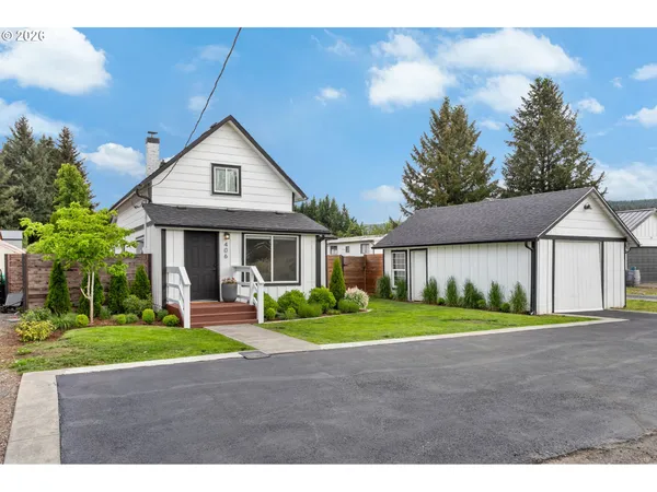 a front view of a house with a yard and garage
