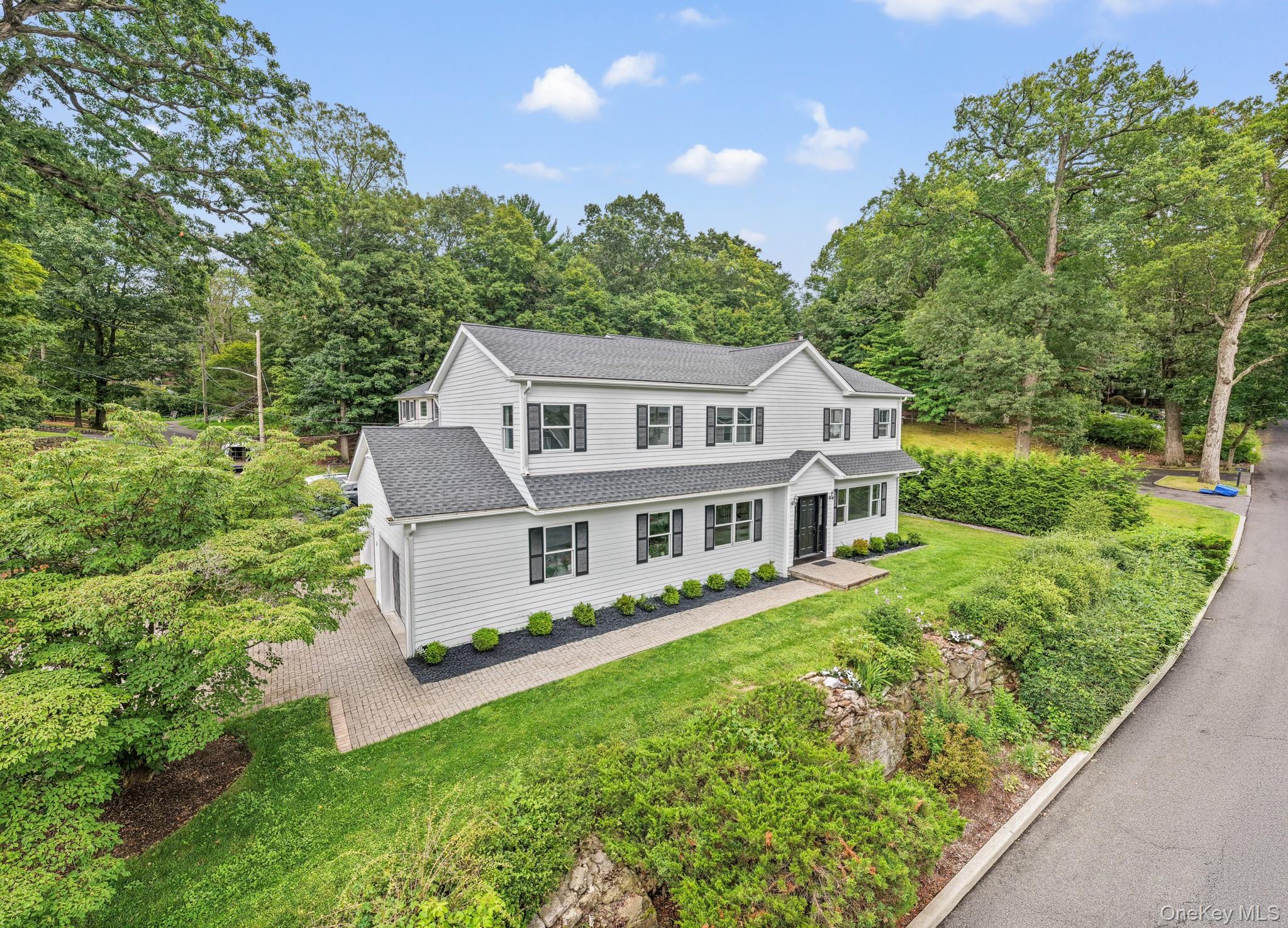 5 Shady Road Ardsley, NY 10502 - Photo 1 of 1 View of front of property featuring a shingled roof, a front yard, and view of scattered trees