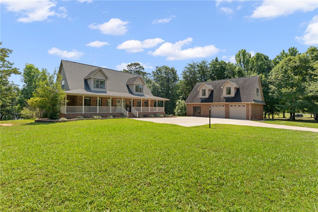 622 Jackson Road Anderson, SC 29626 - Photo 44 of 50 A classic brick-front home with a broad front porch and a detached garage, all nestled in a natural setting.