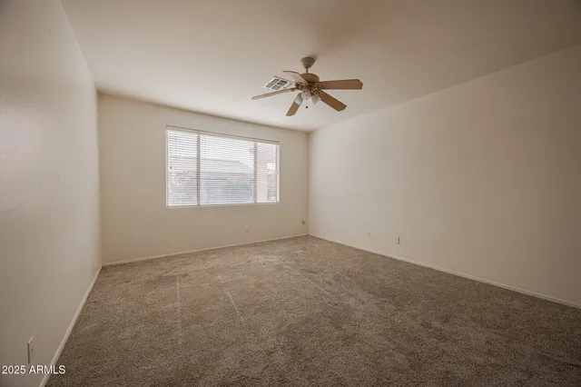 an empty room with windows and closet