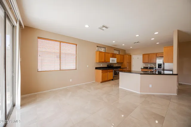 a view of kitchen with microwave and cabinets
