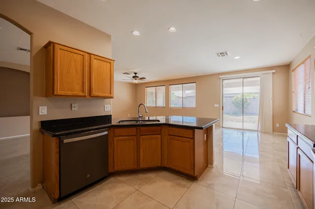 a kitchen with granite countertop a sink and cabinets