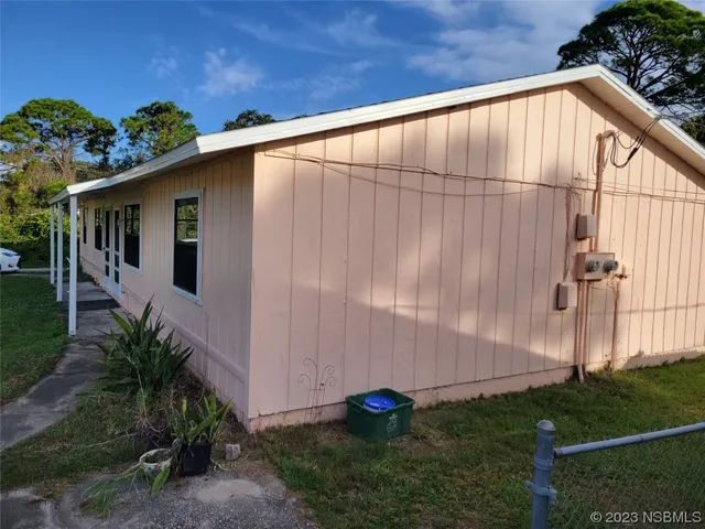 a backyard of a house with plants