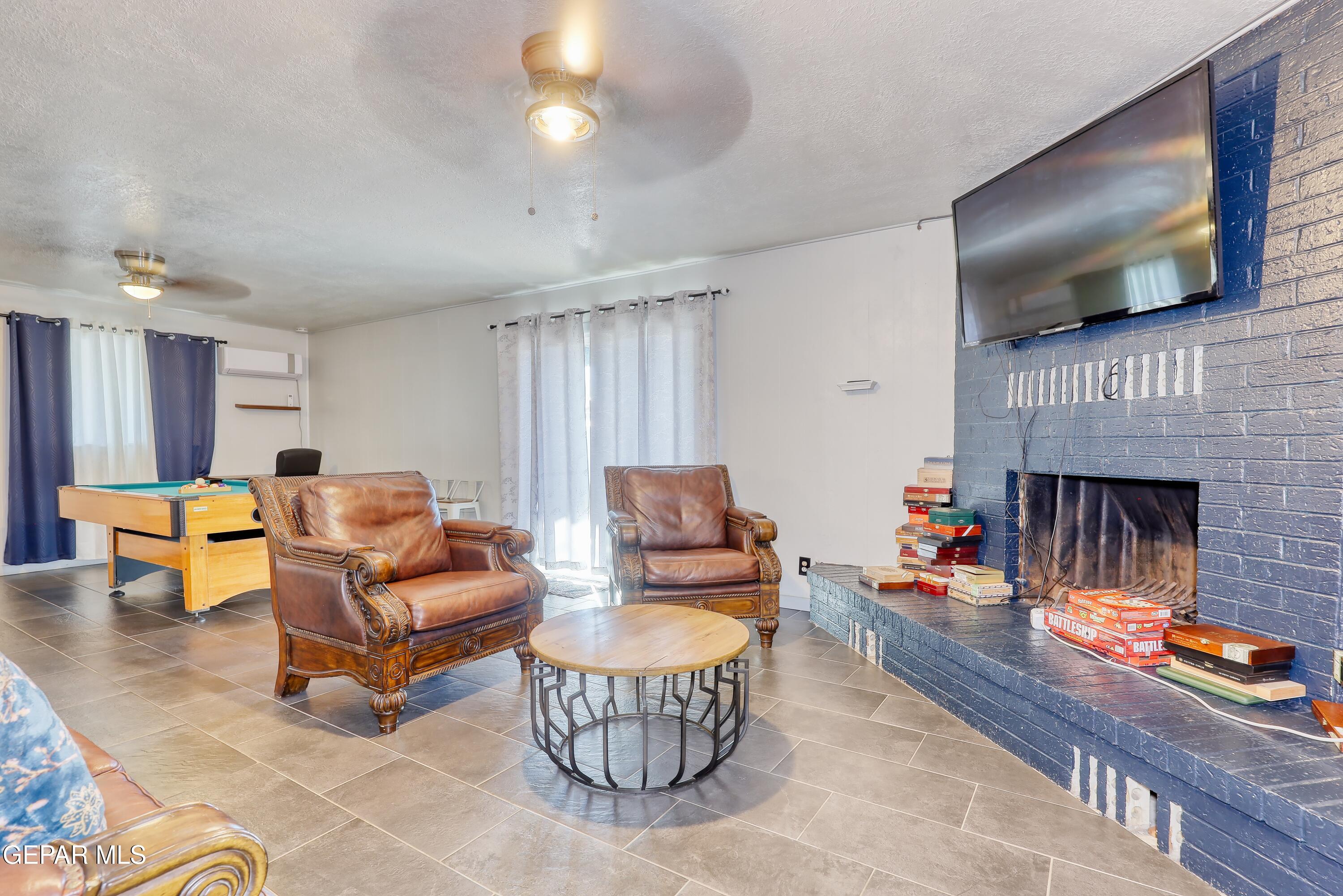 5912 Delta Drive El Paso, TX 79905 - Photo 14 of 37 a living room with furniture and a flat screen tv