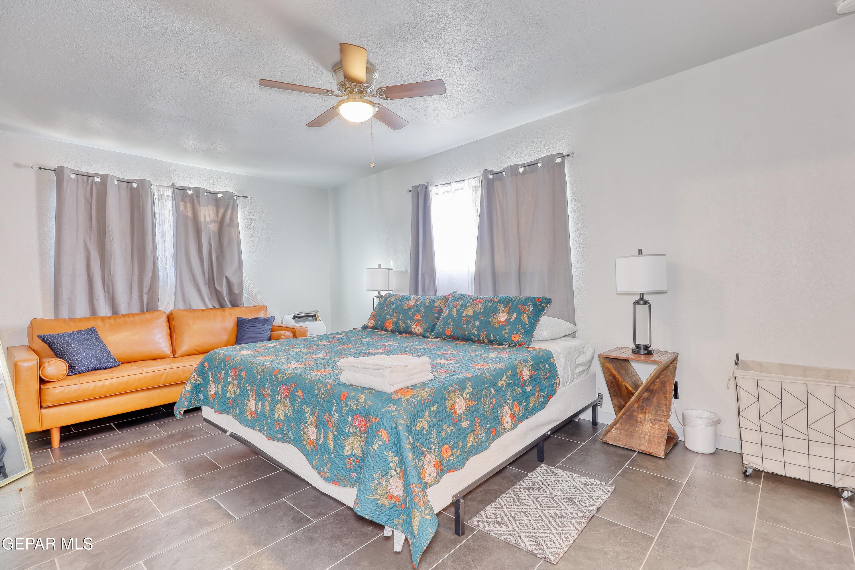 5912 Delta Drive El Paso, TX 79905 - Photo 18 of 37 a bedroom with a bed and a chandelier