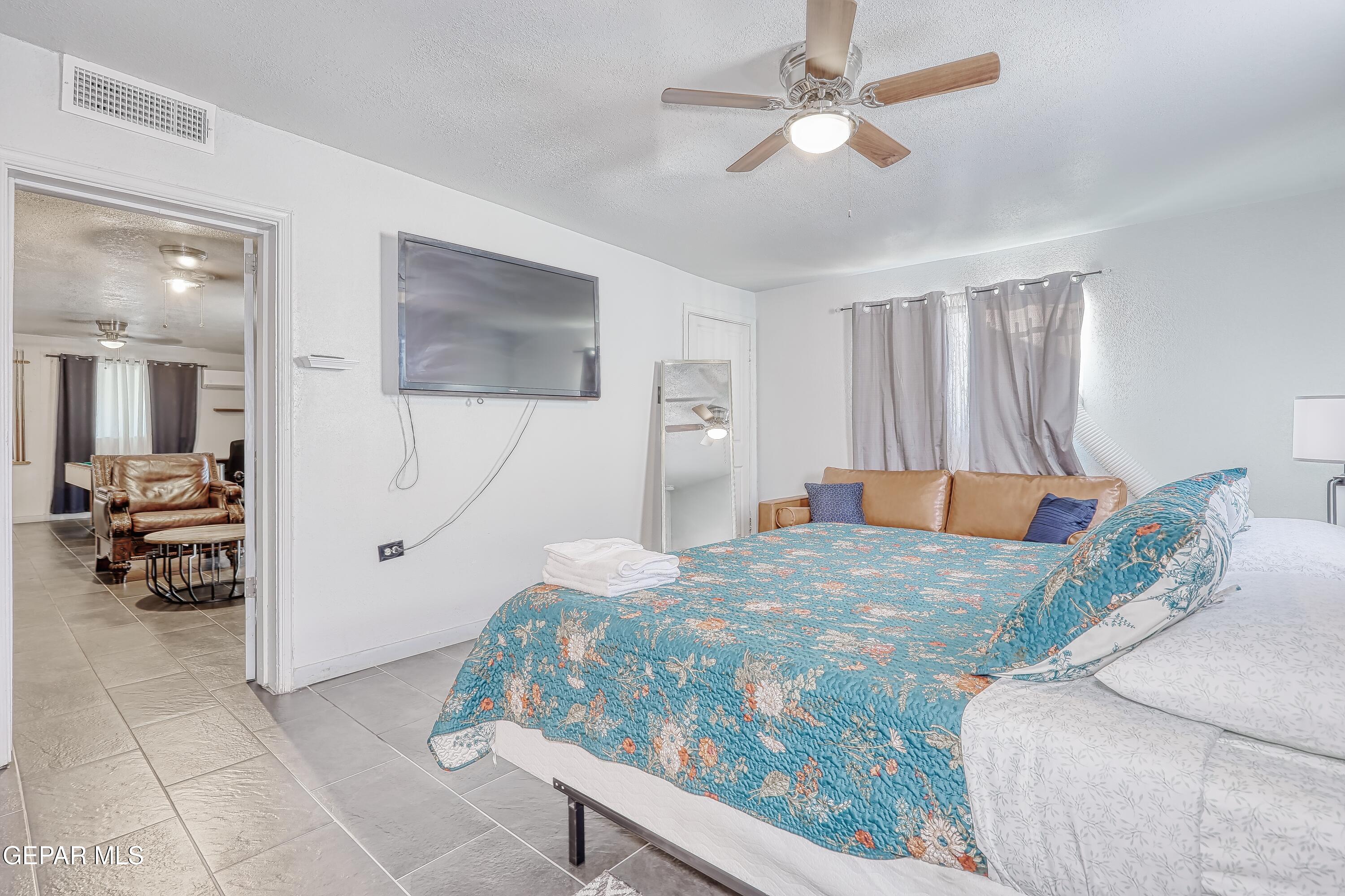 5912 Delta Drive El Paso, TX 79905 - Photo 19 of 37 a bedroom with a bed and a large mirror