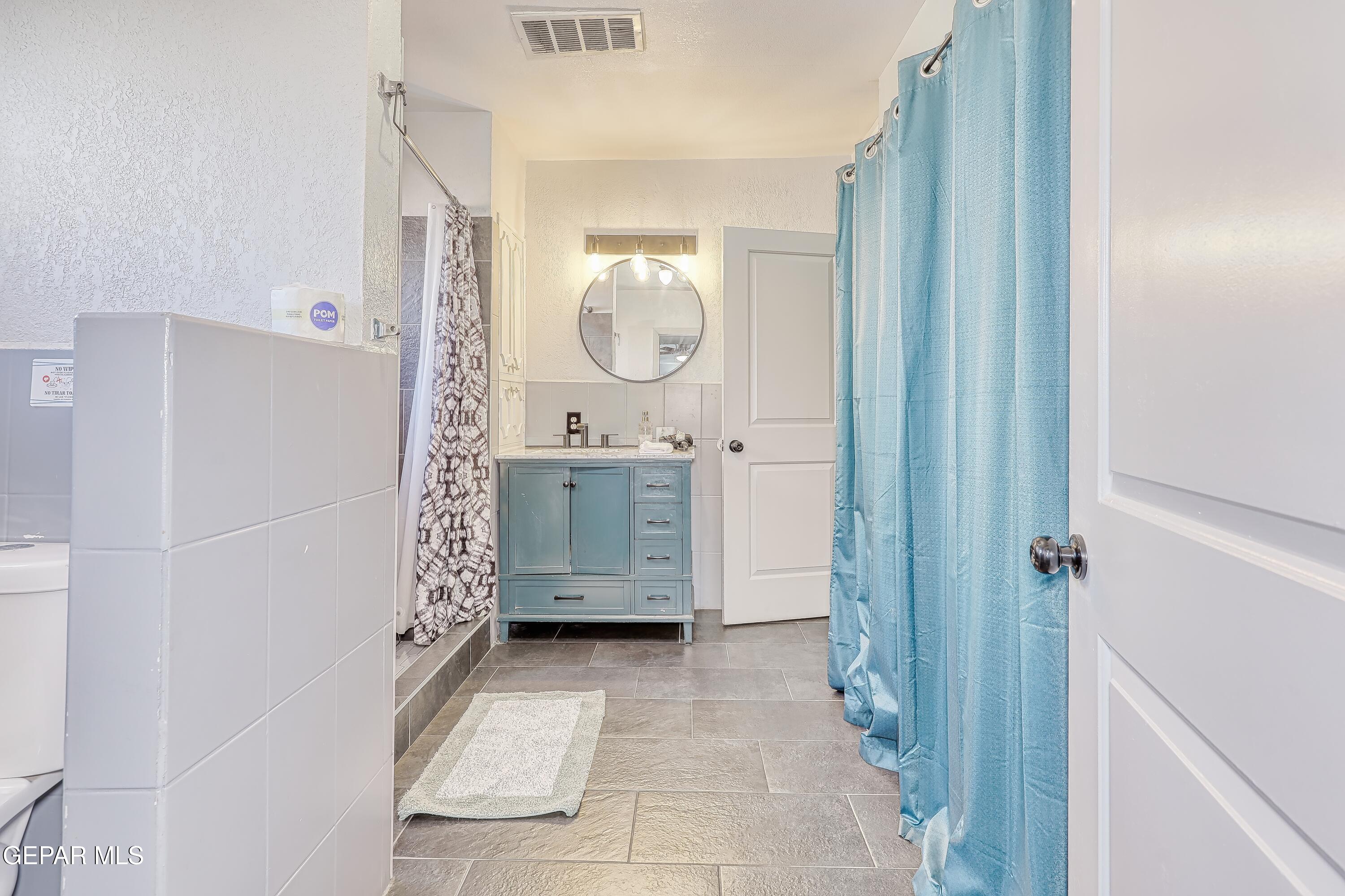 5912 Delta Drive El Paso, TX 79905 - Photo 21 of 37 a bathroom with a mirror a sink and a mirror
