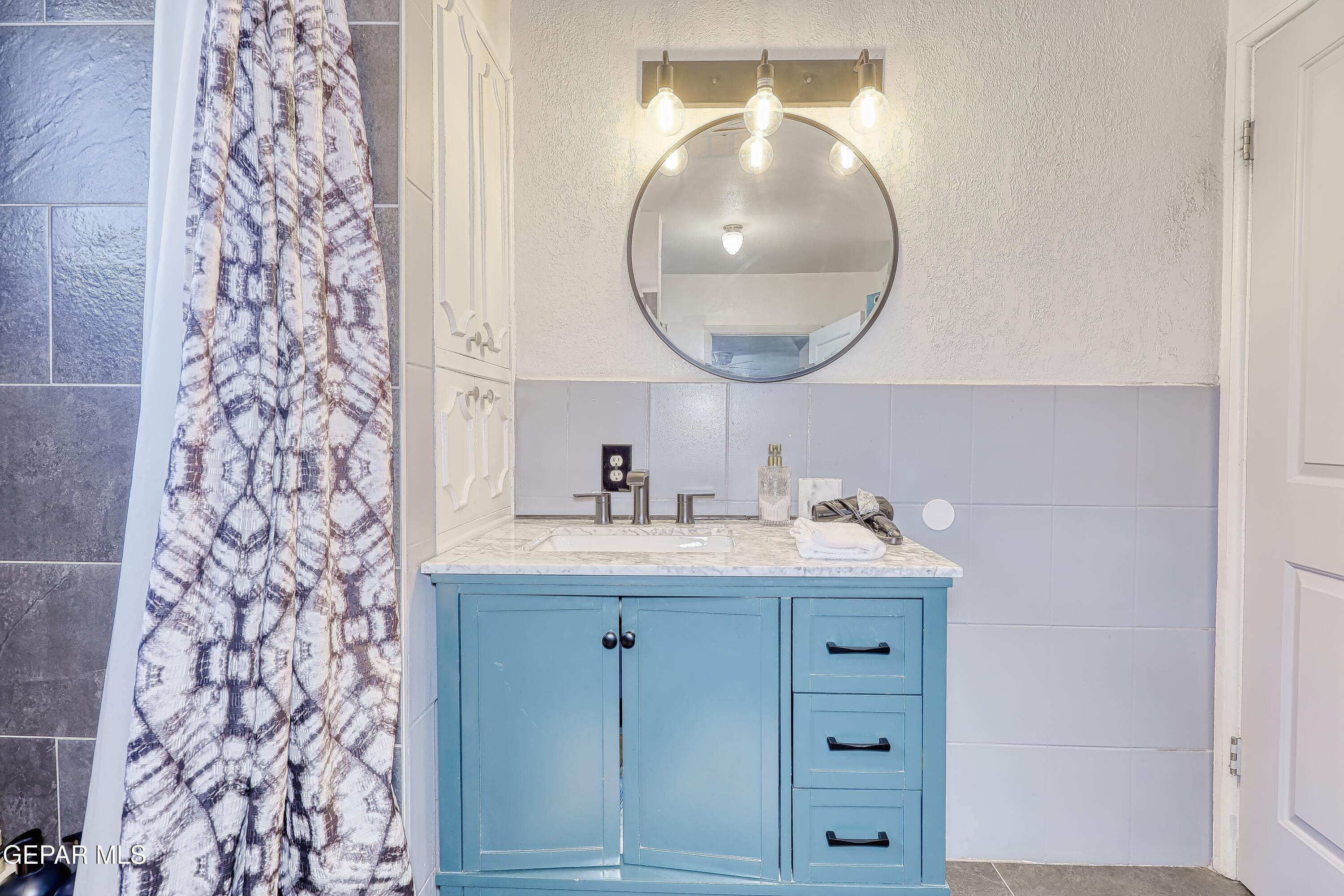 5912 Delta Drive El Paso, TX 79905 - Photo 26 of 37 a bathroom with a sink and a mirror