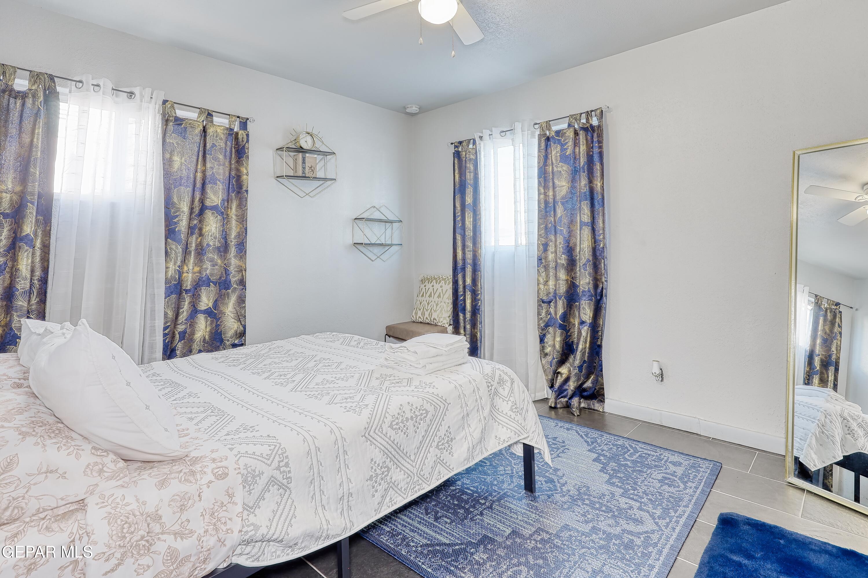 5912 Delta Drive El Paso, TX 79905 - Photo 28 of 37 a bedroom with a large bed and a chandelier