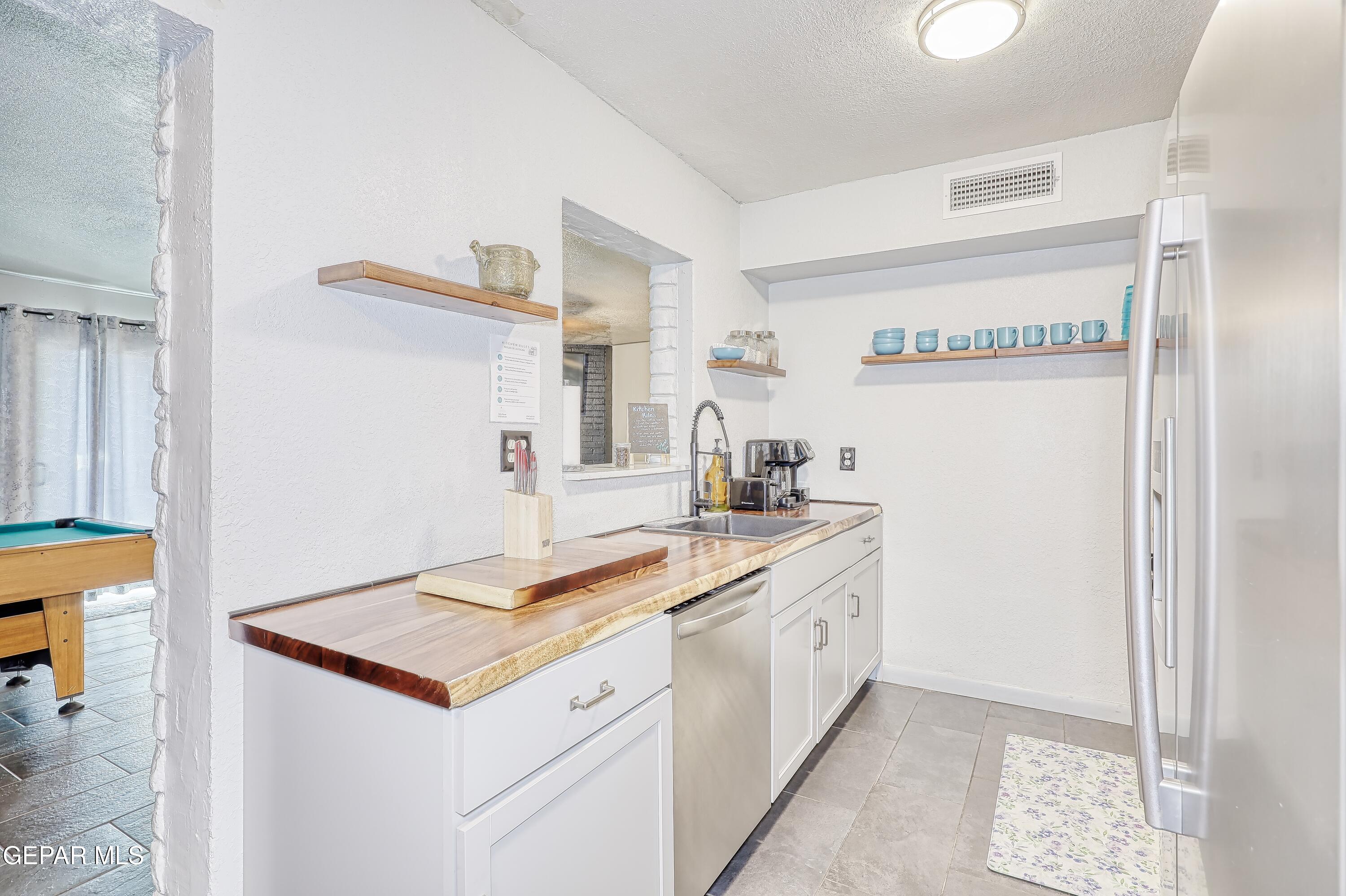 5912 Delta Drive El Paso, TX 79905 - Photo 7 of 37 a kitchen with a sink and a refrigerator