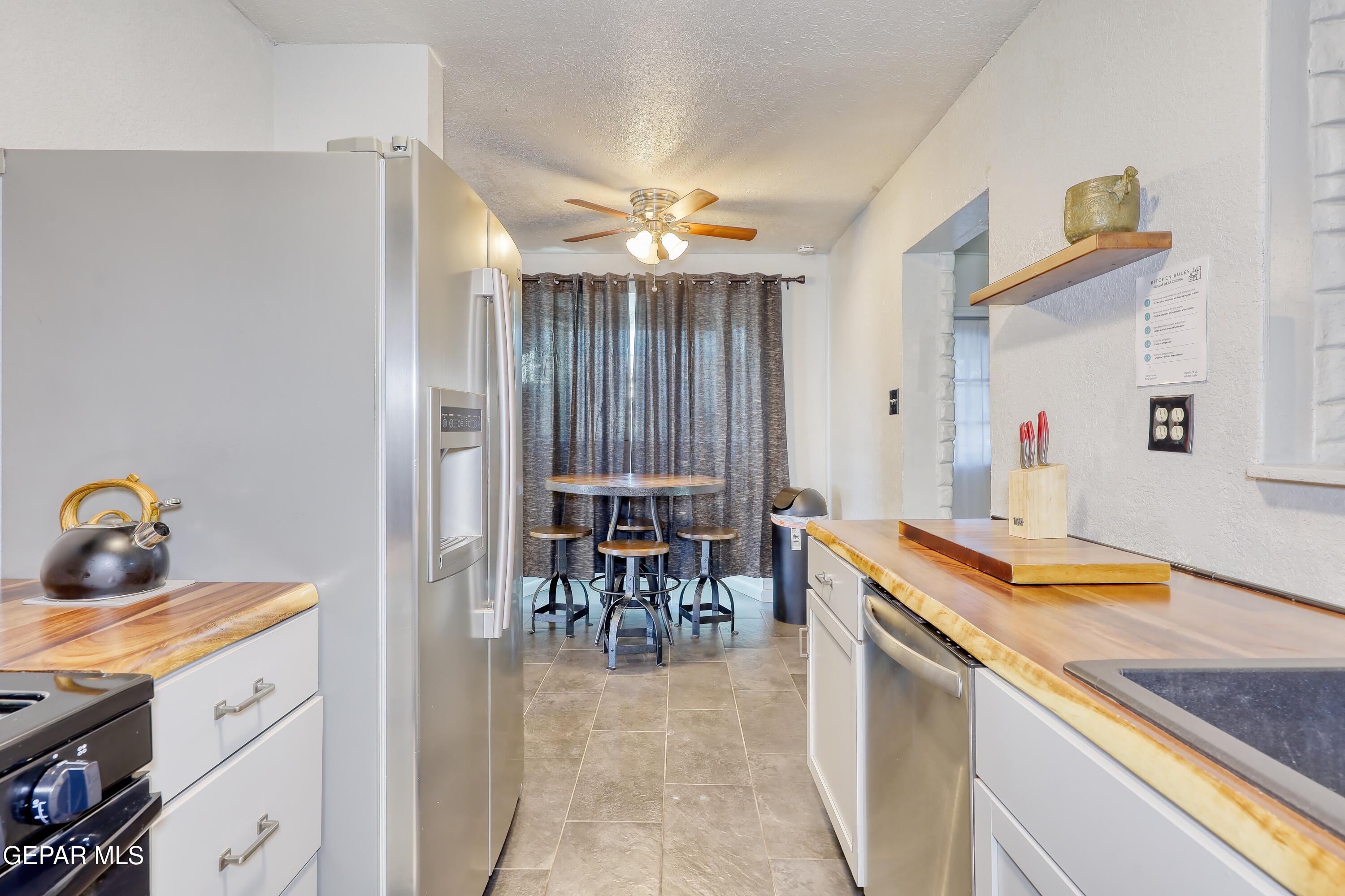 5912 Delta Drive El Paso, TX 79905 - Photo 10 of 37 a dining hall with granite countertop kitchen island stainless steel appliances a table and chairs