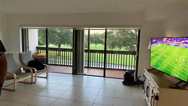 a view of a porch with furniture and backyard