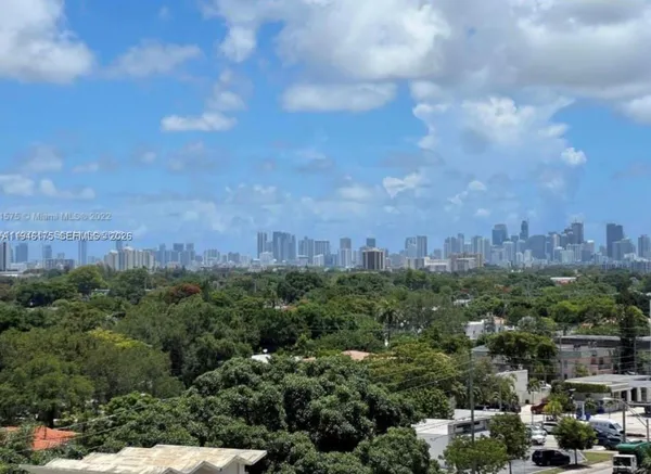 a view of a city with lush green forest