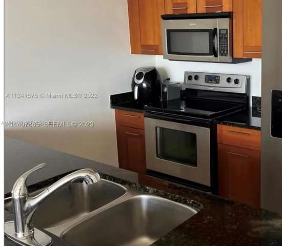 a kitchen with a stove microwave and sink