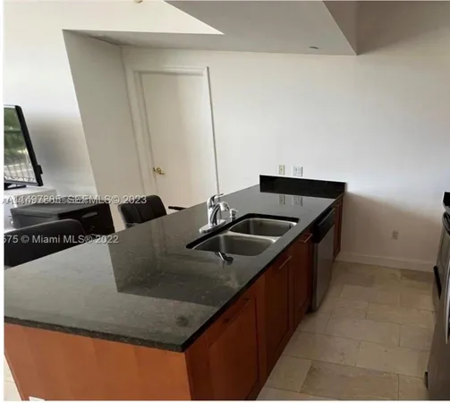 a kitchen with a sink and a refrigerator