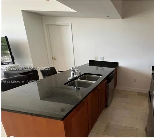 a kitchen with a sink and a refrigerator