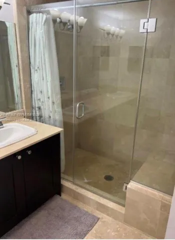 a bathroom with a shower and a sink