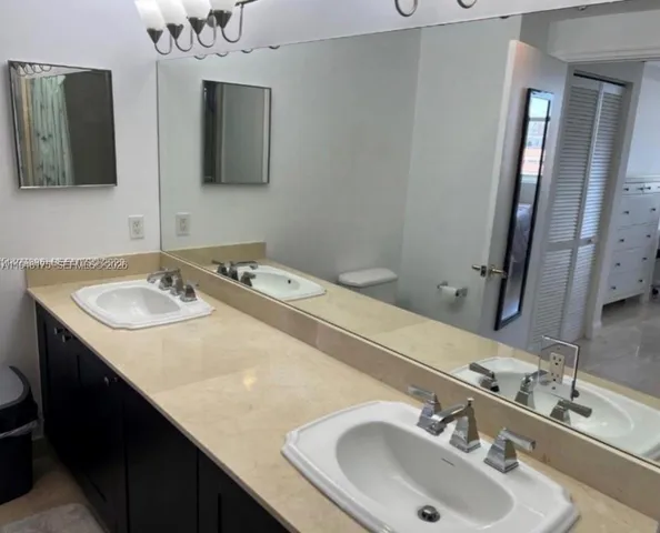 a bathroom with a sink double vanity and a mirror